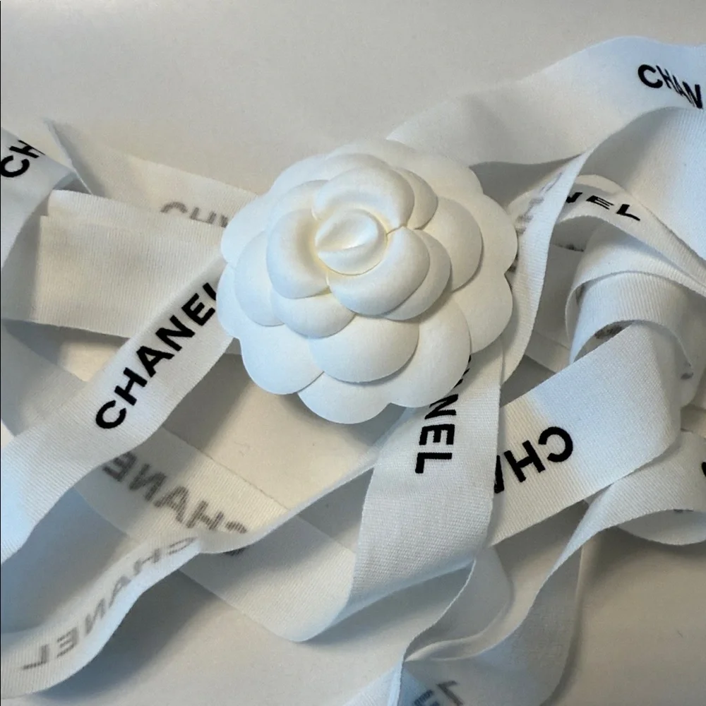 CHANEL 1 CAMELIA FLOWER AND Silver Chanel printed RIBBON,  plus Chanel card.